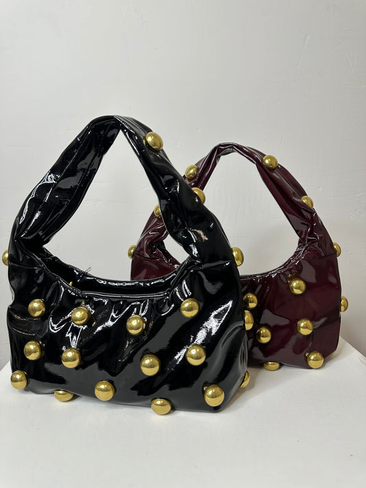 BORSA MEZZALUNA CON BORCHIE